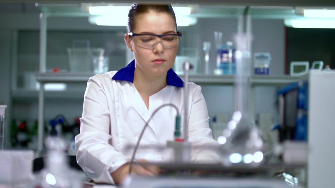 Female scientist preparing for experiment in pharmaceutical laboratory