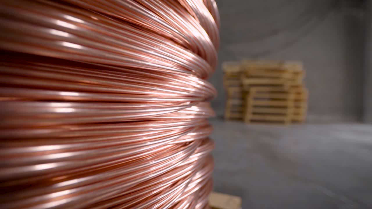 Copper rod. Thick copper wire coiled into a huge bobbin. Copper is one of the rare metals used everywhere