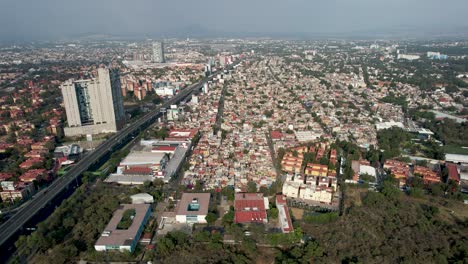 backwards-drone-shot-of-Cuicuilco-pyramid-in-Mexico-city-near-poor-neighborhoods