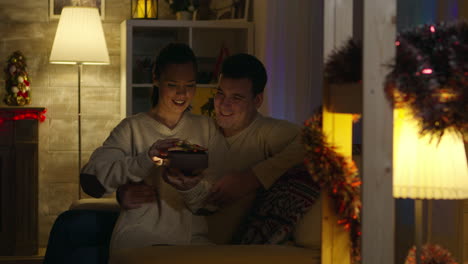 young woman opening gift with magical shine