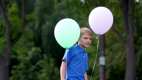 little boy playing with baloons. young boy with baloons spending time outdoor