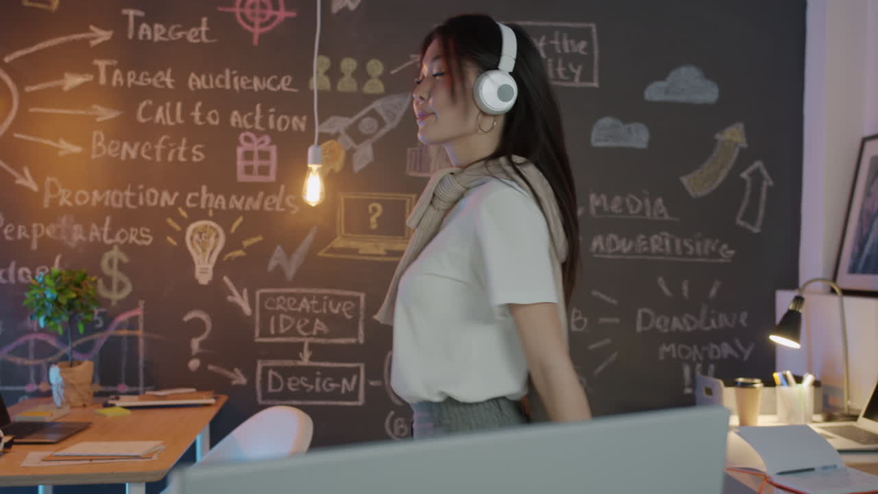 Happy woman dancing in the office