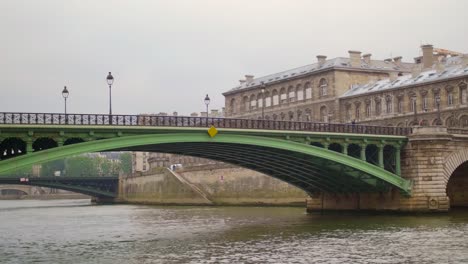 camera panning over the historic notre-dame bridge located on river seine in paris