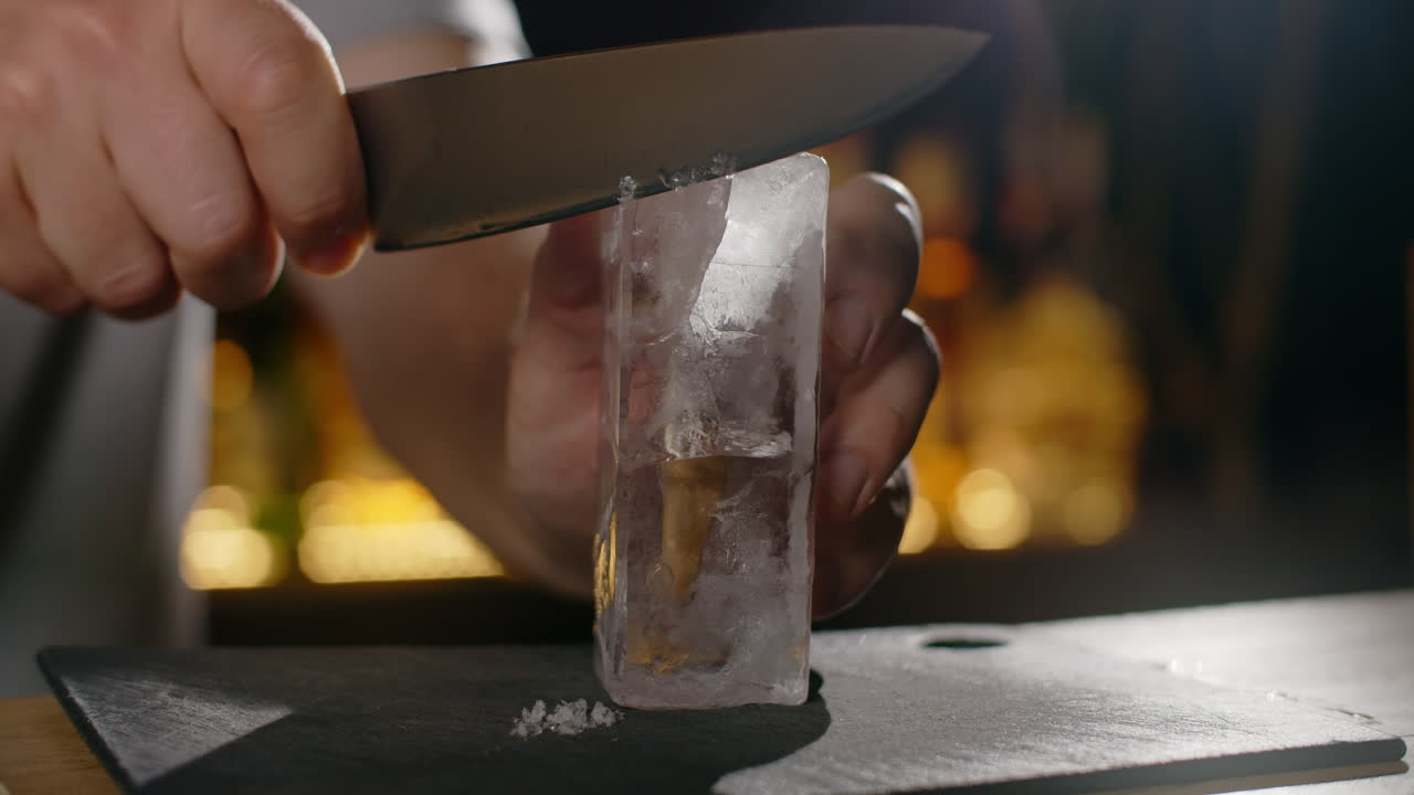 Bartender Cutting Ice for Cocktails