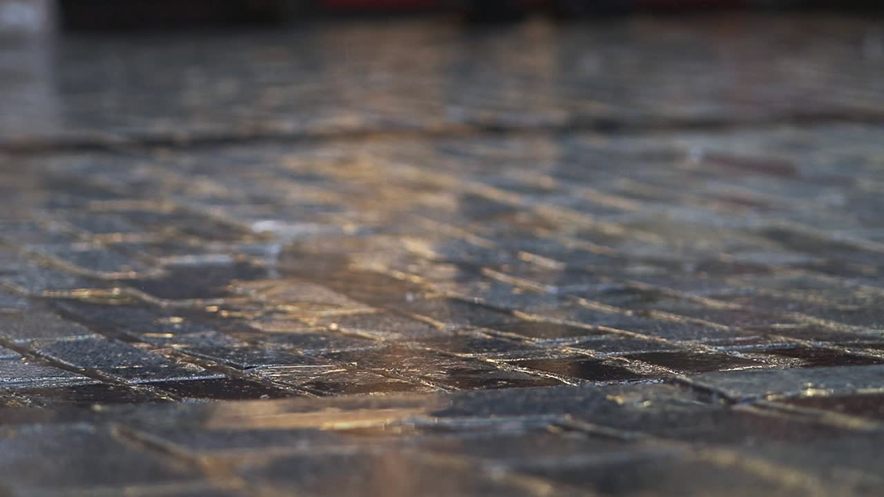 Feet Walking on Wet Pavement with Raindrops Splashing