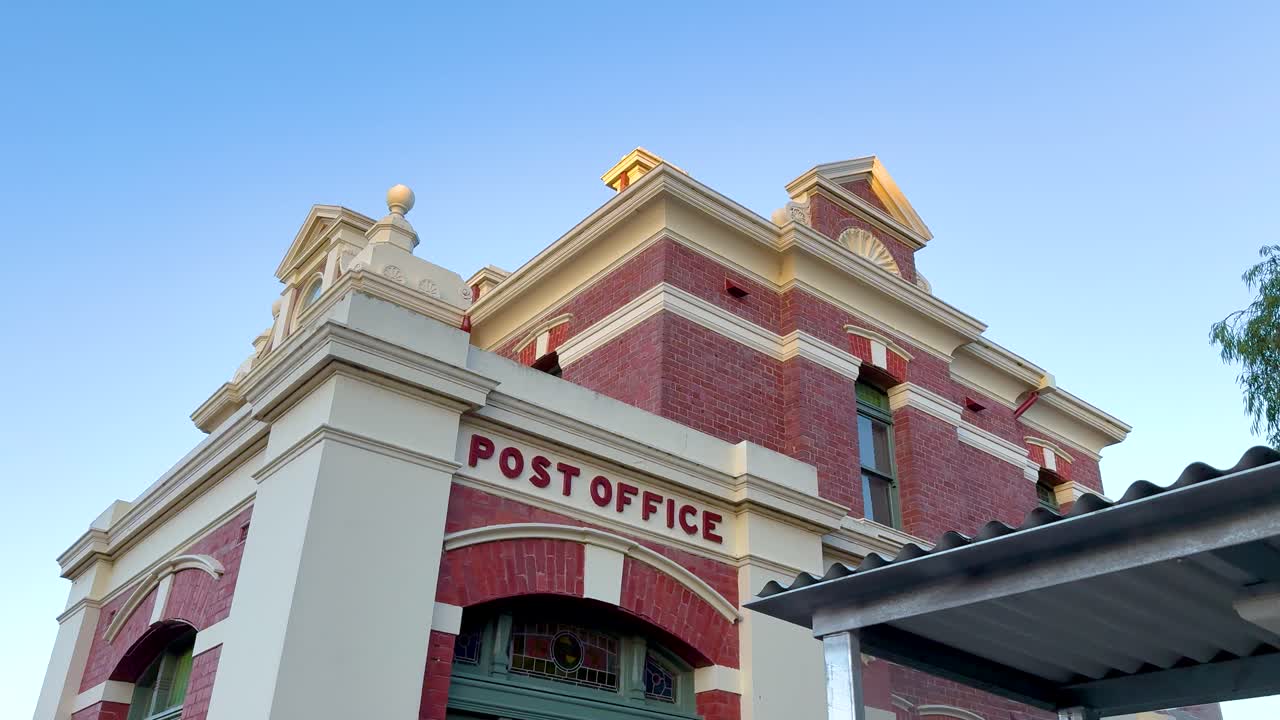 A series of frames showing the historic Queenscliff Post Office against a clear evening sky, highlighting architectural details