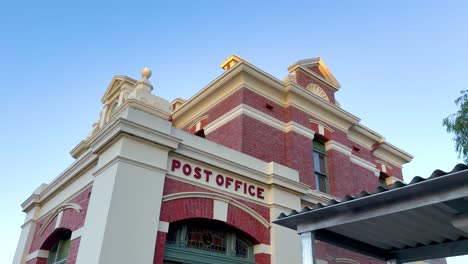 a series of frames showing the historic queenscliff post office against a clear evening sky, highlighting architectural details