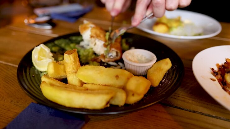 Hand grabbing food from a plate