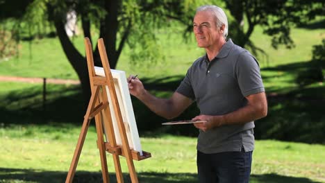 Old-male-painting-a-canvas