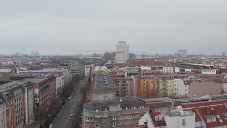 AERIAL:-Slow-flight-through-Empty-Central-Berlin-Neighbourhood-Street-Torstrasse-over-Rooftops-during-Coronavirus-COVID-19-on-Overcast-Cloudy-Day