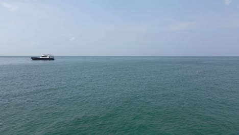 Low-aerial-flyby:-Fishing-boat-in-Thailand-with-several-lines-in-ocean