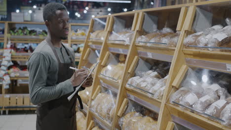 grocery store employee checking inventory