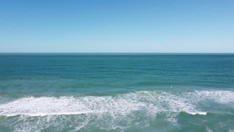 Drone-flying-aerial-shot-over-ocean-waves