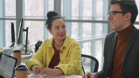 Colleagues-Having-Discussion-at-Business-Meeting-in-Office