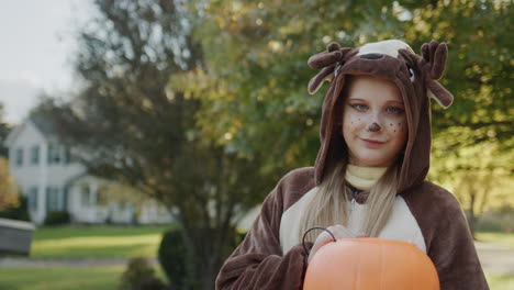 Portrait-of-a-child-dressed-as-a-reindeer-with-a-candy-basket.-Against-the-backdrop-of-typical-American-houses-in-the-distance