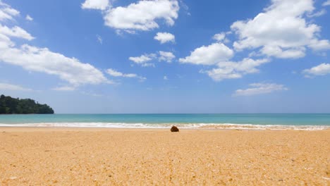 white fluffy clouds footage, beautiful sunny day abstract color sky. clouds traveling fast in blue sky with a ripple of seawater waves on the sandy shore. traveling in summer holiday to the beach