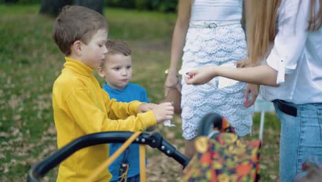 little children wipe their faces with napkins