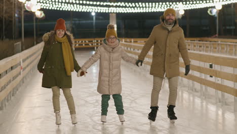 family ice skating at night