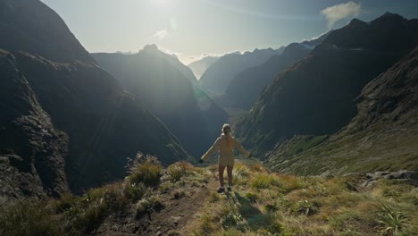 Woman-reaching-breathtaking-viewpoint-throwing-arms-in-air-out-of-happiness