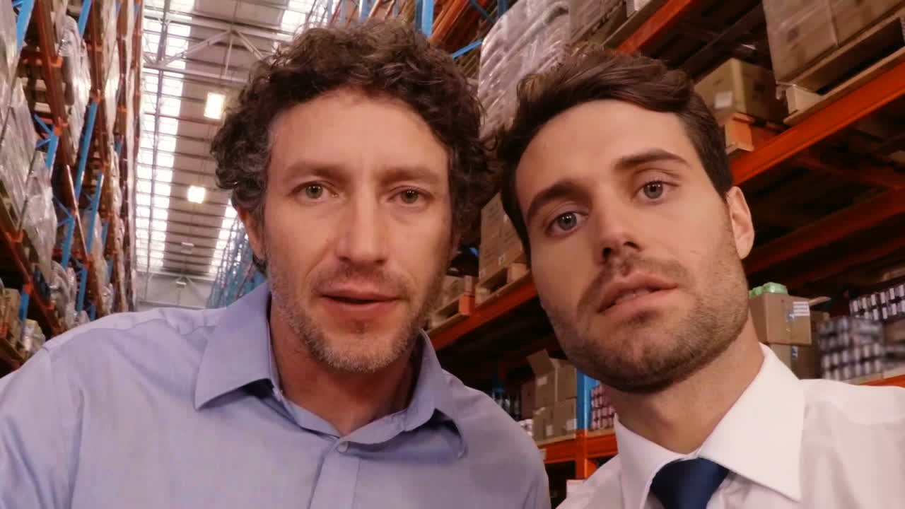 Portrait of warehouse supervisor and manager interacting with each other