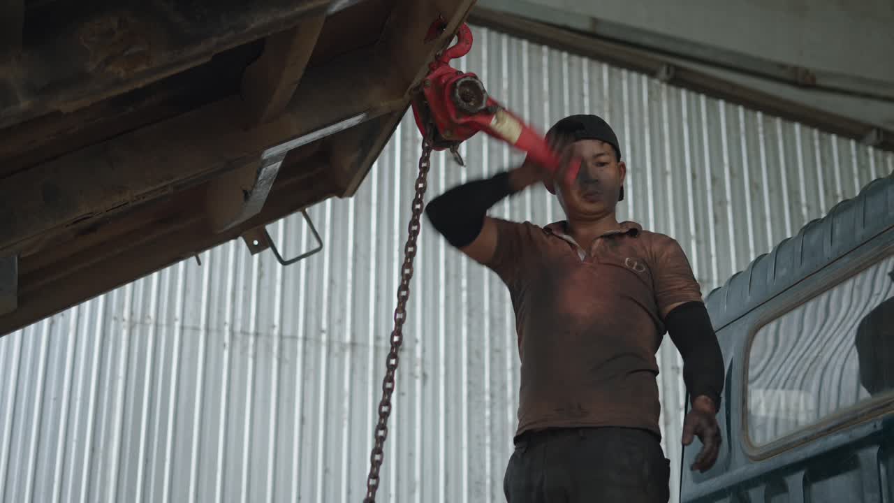 Truck Mechanic Working on a Trailer