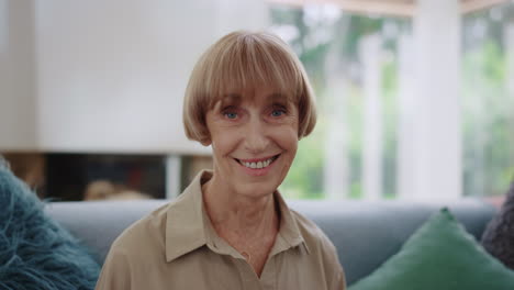 joyful woman sitting on couch at home