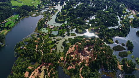 Sonnige-Himmelsreflexionen-Auf-Dem-Seewasser-Mit-Vegetation-Im-Dorf-Amatciems,-Lettland