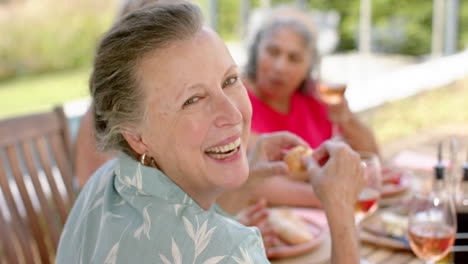 Senior-biracial-woman-enjoys-a-meal-outdoors