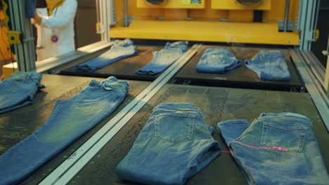 denim factory using laser beams to make design on blue jeans