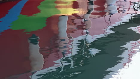 reflection of a boat in the rippling waters of a marina in alicante,spain