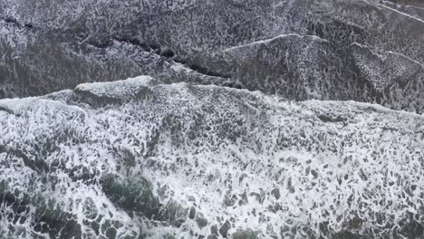 Aerial-top-down-sideways-view-over-big-ocean-waves-at-Seal-Rock-in-Oregon