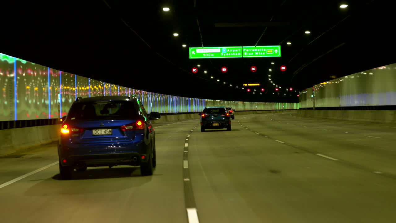 POV car Driving through a long tunnel, Sydney Australia