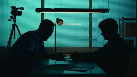 medium silhouette video of a offender perpetrator or prisoner sitting in the room the detective medium silhouette video of a offender perpetrator or prisoner sitting in the room the detective brings him a cup of water and begins the interrogation process true crime documentary creative