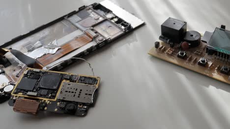disassembled mobile phone circuit board and electronic components on the table