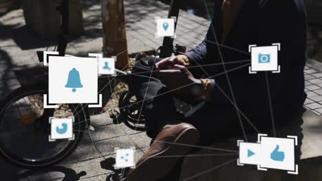 network of digital icons against mid section of person using smartphone on the street