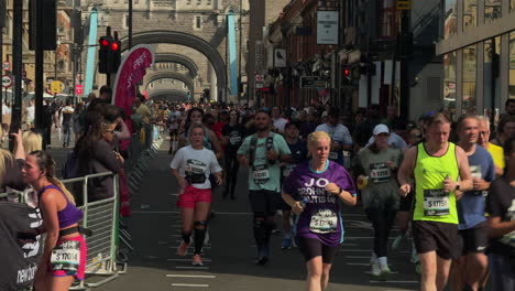 fun runners travel south on tower bridge road, london in the big half 2024
