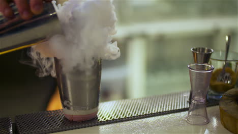 bartender preparing dry ice drink at club 1