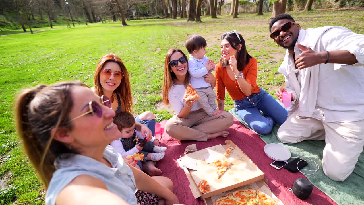 Group picnic in the park with pizza