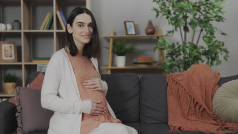pregnant woman sitting on a sofa