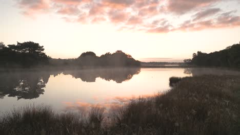 misty sunrise over a calm lake