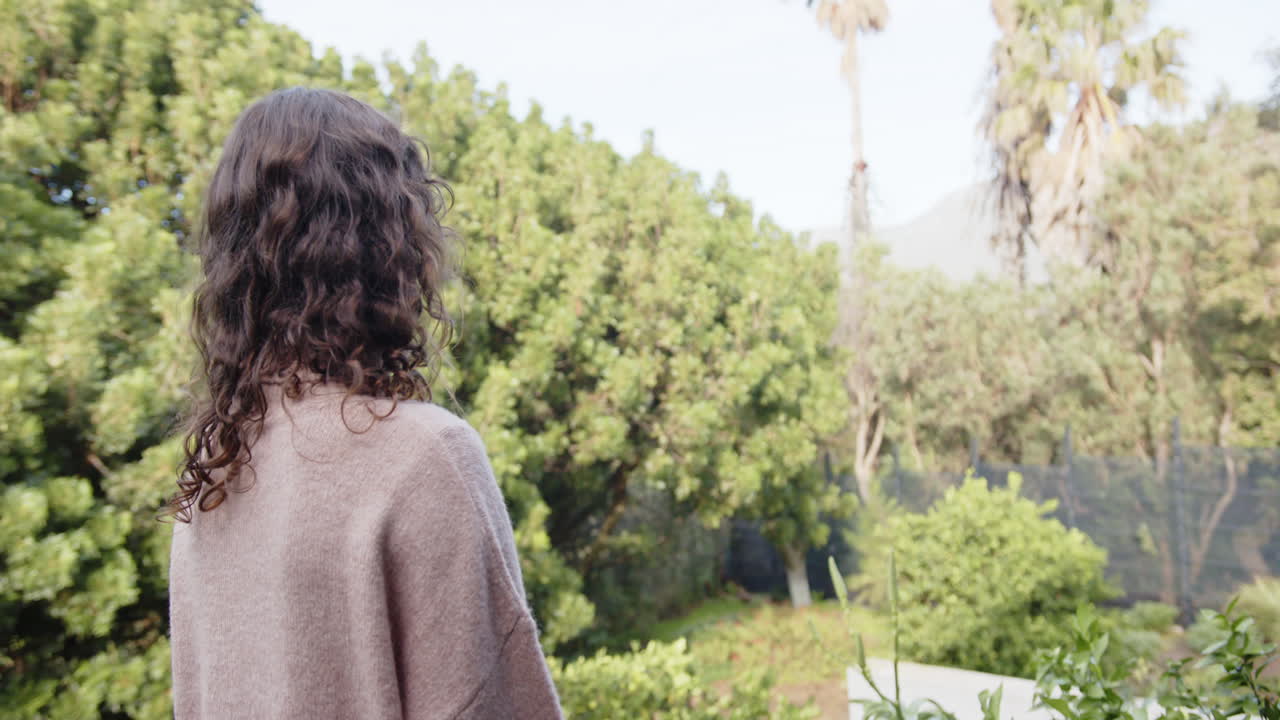 Relaxing outdoors, woman enjoying peaceful garden view at home retreat, copy space