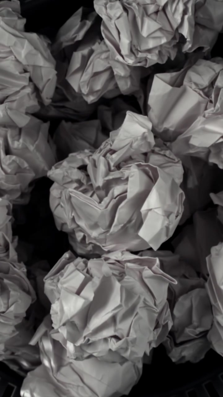 Rack Focus on Crumpled White Paper Balls in a Bin