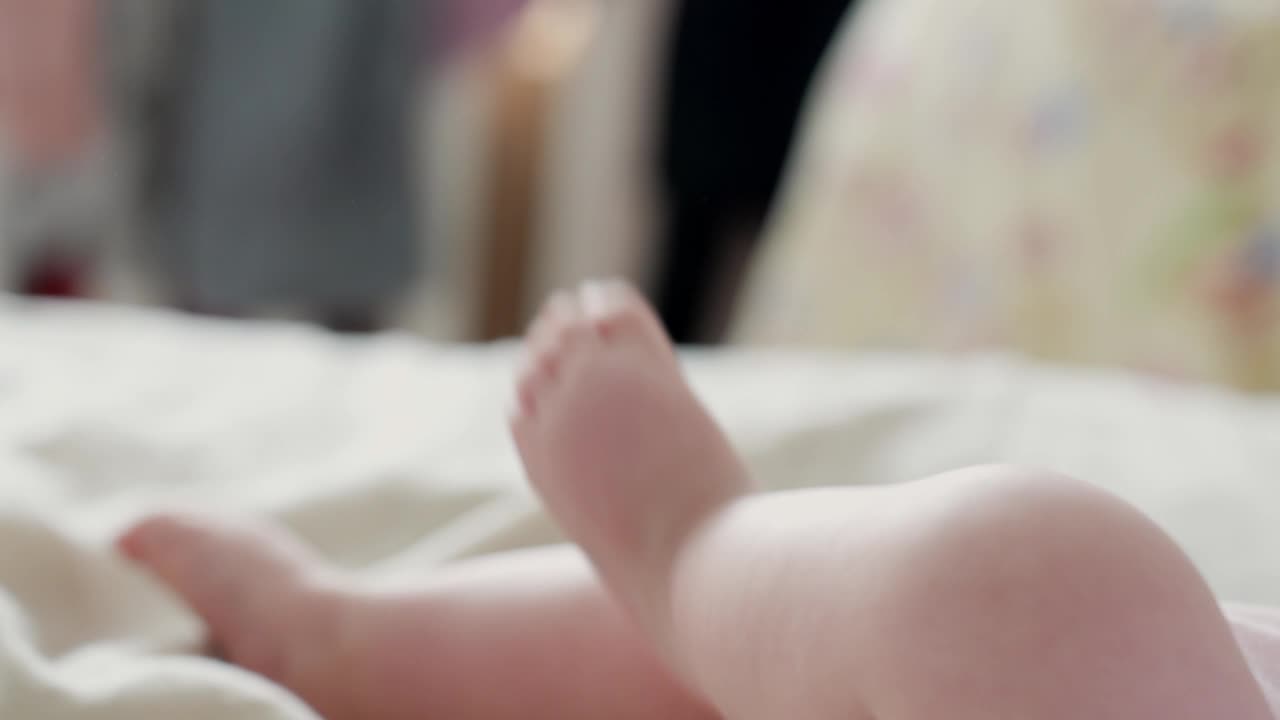 可愛らしく小さな赤ちゃんの足のクローズアップ。脚をばたつかせている様子。