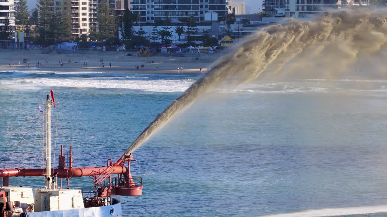 Aerial view of a dredging vessel pumping sand into the ocean, highlighting coastal management efforts on the Gold Coast