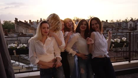 Close-Up-Of-Fashionable-Girls-In-The-Same-Casual-Clothes-Seductively-Dancing,-Posing-In-Front-Of-The-Camera-On-The-Terrace