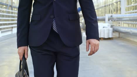 man in business suit carrying briefcase