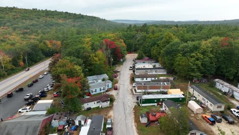 aerial shot of trailer park nestled among fall forest foliage in the american northeast