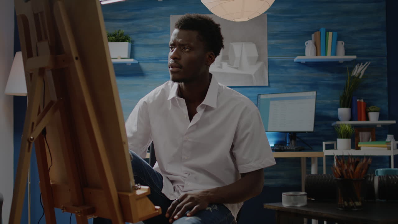 Black artist analyzing vase for drawing design