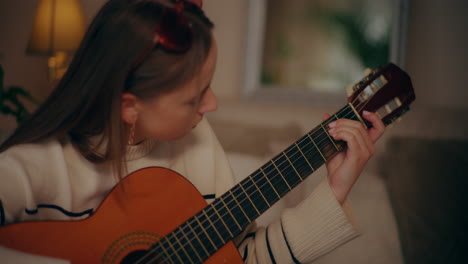 woman playing guitar writing song composing music