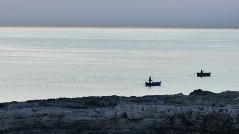 aerial footage off the coast of monopoli revealing to fishermen on their boats on the mediterranean